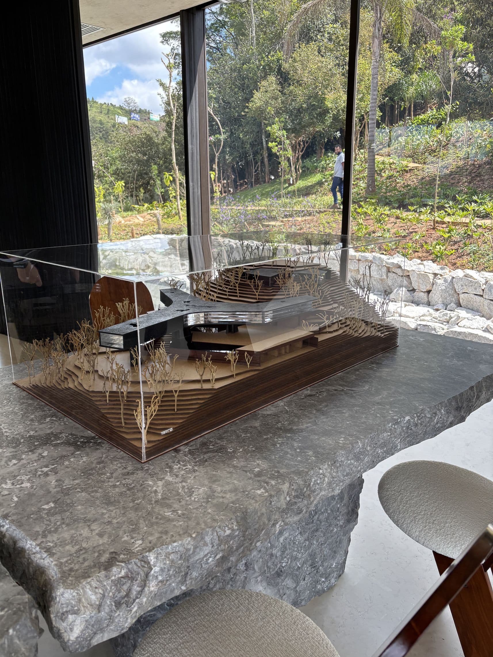 Maquete da Casa Xingu em caixa de acrílico com terreno em camadas de madeira